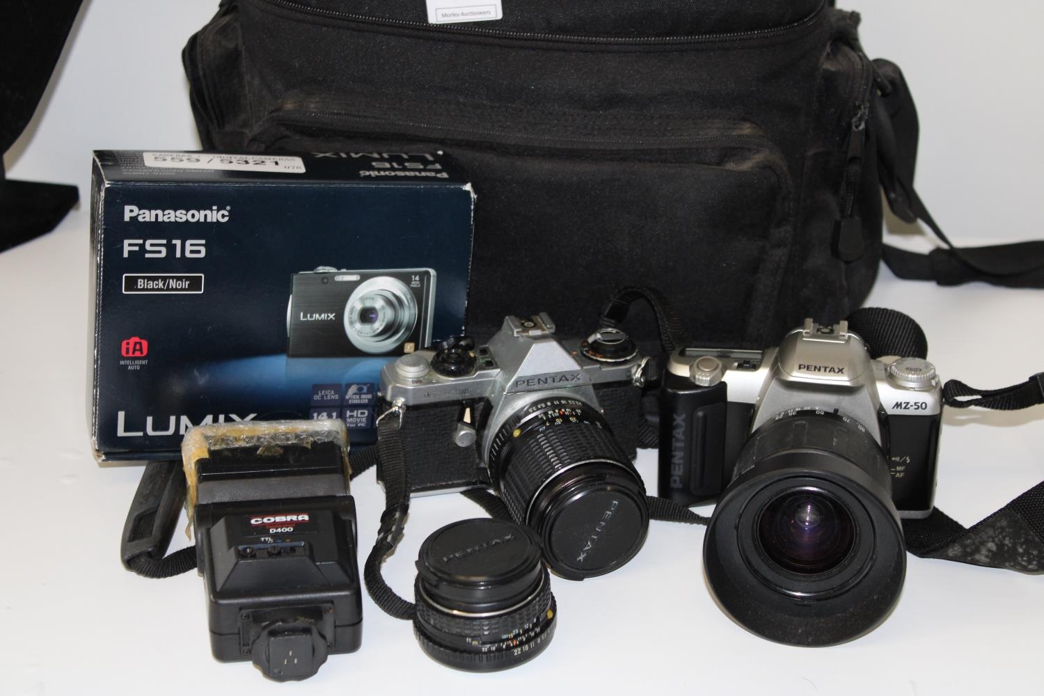 A camera case with two Pentax camera's & lenses etc