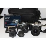 A camera case with two Pentax camera's & lenses etc