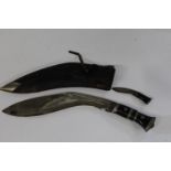 A vintage Kukri knife with smaller blade in sheath