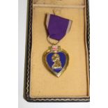 A copy of a Purple Heart medal in presentation box