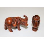 Two hand carved netsukes (hand & water buffalo)