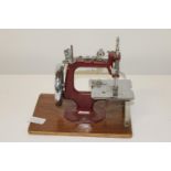 A vintage miniture table top sewing machine