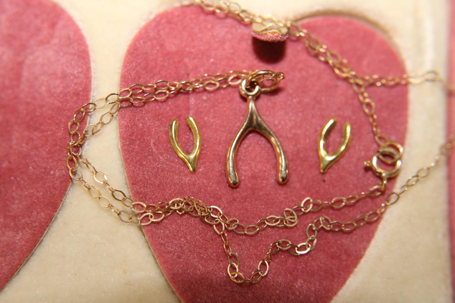 A boxed set of 9ct gold earrings & necklace with wishbone pendant