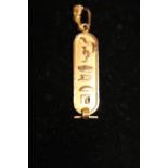 A tests for 14ct-18ct gold Egyptian themed pendant 2.9 grams