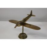 A vintage brass desk top model of a Spitfire