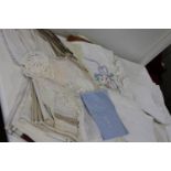 A basket full of vintage linen & other items