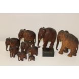 A herd of vintage wooden elephants, and wooden box & contents (sold as seen)