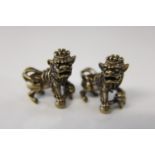 A pair of small Chinese bronzed foo dogs