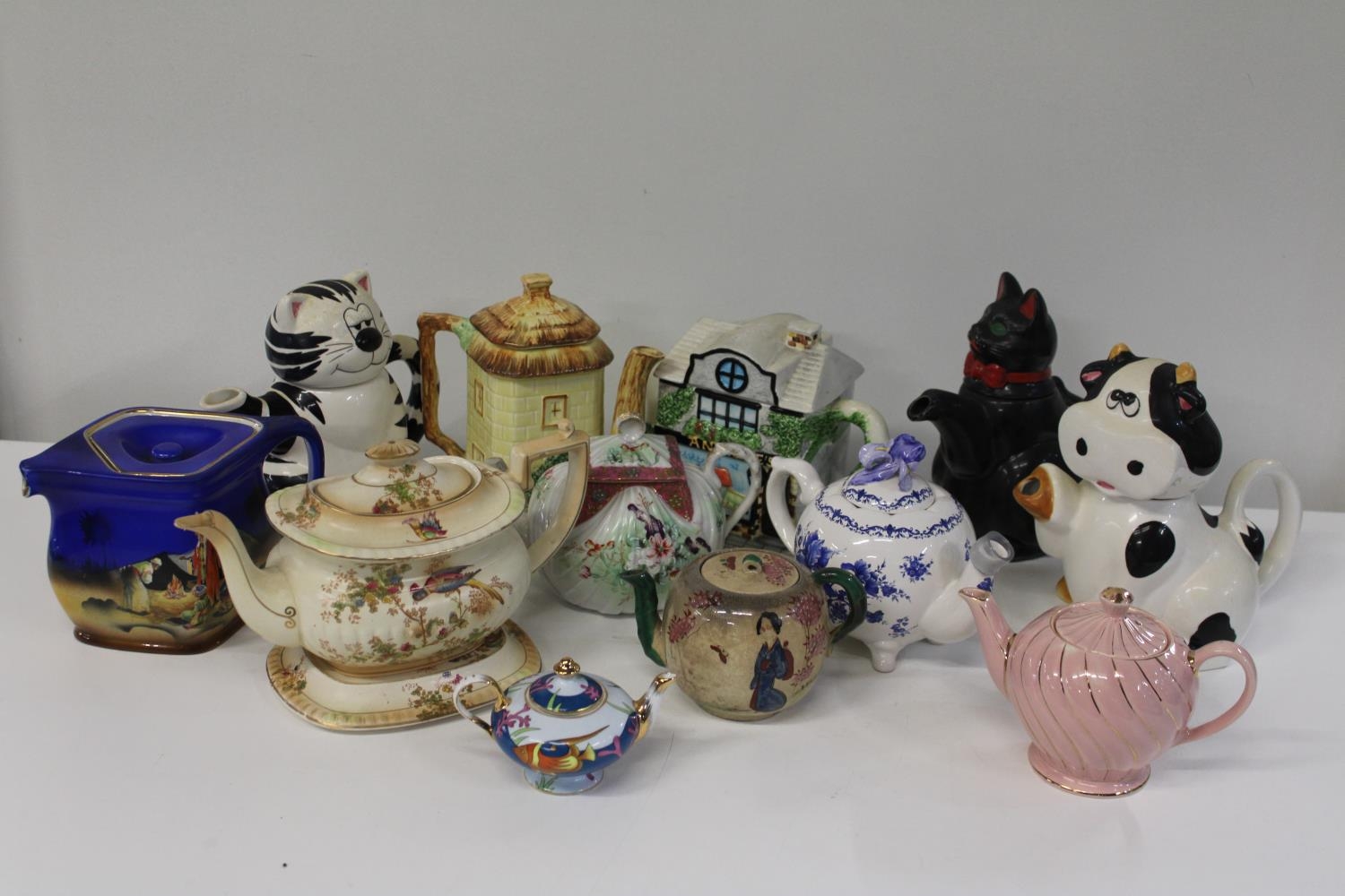 A box full of collectable tea pots (sold as seen) collection only