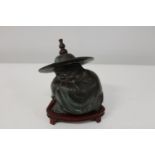 A Chinese bronze figure on wooden stand 17x16cm
