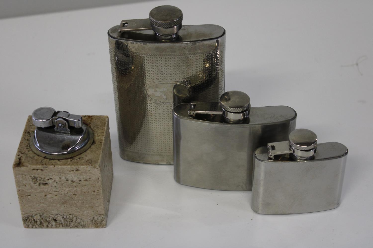 Three vintage hip flasks & a table lighter