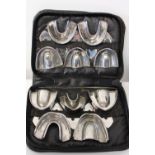 A vintage set of metal dental moulds