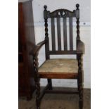 A Victorian oak elbow chair
