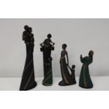 A group of four 'Mahogany Princess' figurines
