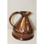 An antique copper gallon jug