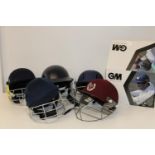 A job lot of assorted cricket helmets etc