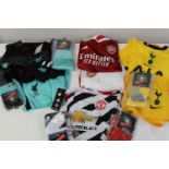 A selection of kid's football shirts & short sets