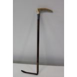 A vintage horn handled riding crop with a hallmarked silver collar