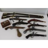 A job lot of re-production flintlocks, wall hangers and a vintage brass powder horn etc (longest gun