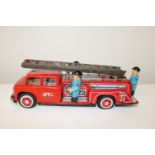 A vintage tin plate fire truck