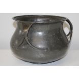 A Liberty & Co Tudric pewter jardinere. A planished planter of circular form with three handles,