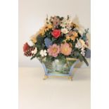 A vintage ceramic flower arrangement in a beautiful pot.