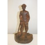 A vintage cast iron door stop in the form of a golfer 36x20cm
