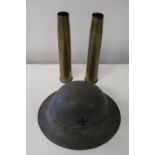 A WW2 period military helmet & two brass shell cases