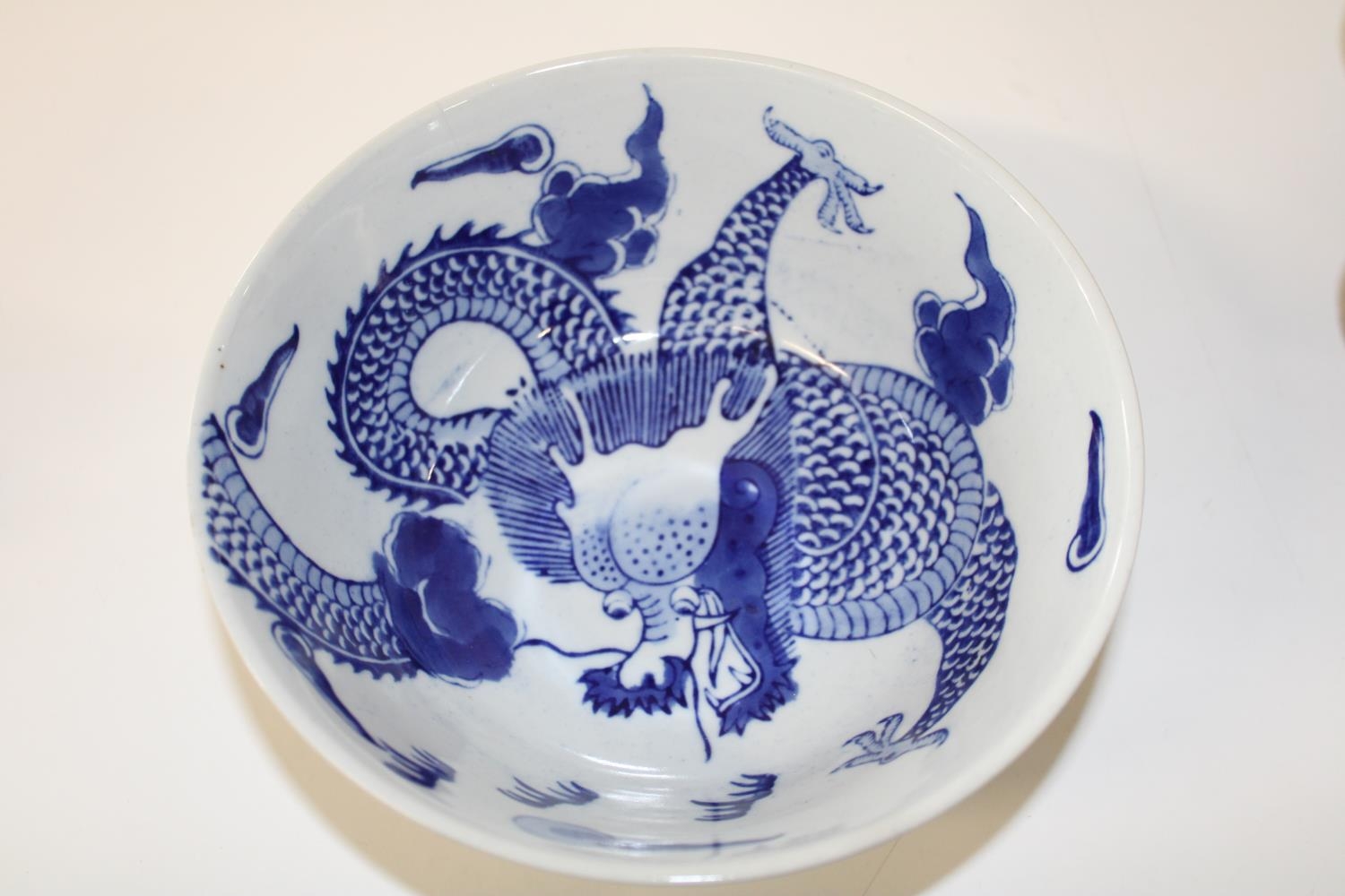 A Chinese blue & white bowl with dragon decoration & marks to the base