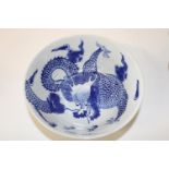 A Chinese blue & white bowl with dragon decoration & marks to the base