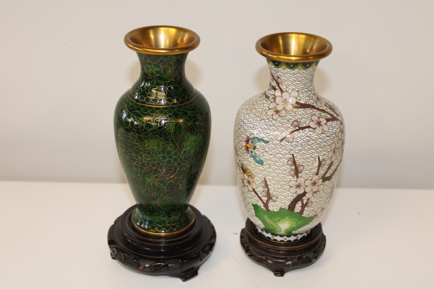 Two Oriental cloisonne vases on wooden stands. 18cm h