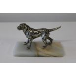 A silver plate dog sculpture on a onyx base. h12cm