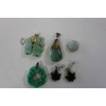 A selection of Chinese jade pendants with yellow metal fittings