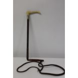 A vintage Moss Bros riding crop