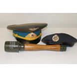 A RAF beret & Russian General's cap, along with a dummy German stick grenade