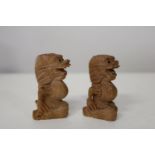 Two hand carved wooden netsukes signed to the base