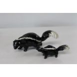 Two Beswick skunk figures