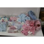 A job lot of new baby clothes etc