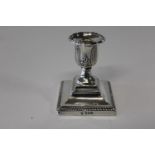 A hallmarked silver squat candle stick 9cm h
