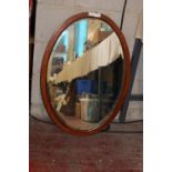 A large oval framed bevelled edged vintage mirror. 81cm x 57cm collection only