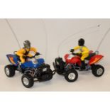 Two remote controlled battery powered quad bikes working