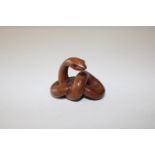 A boxwood netsuke in the form of a cobra