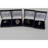 Four boxed Elizabeth Duke brooches