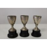 Three small 925 hallmarked silver trophies on plinths. h 8cm