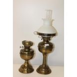 Two vintage brass oil lamp bases one with shade