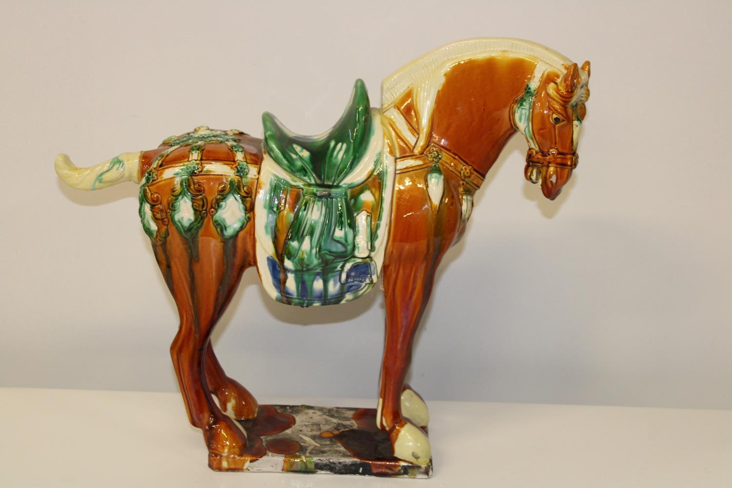 A large ceramic Chinese Tang horse with character marks to the base ( tail has been off & re-glued).