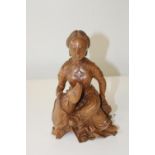 A finely carved wooden Oriental figural sculpture. 23cm tall