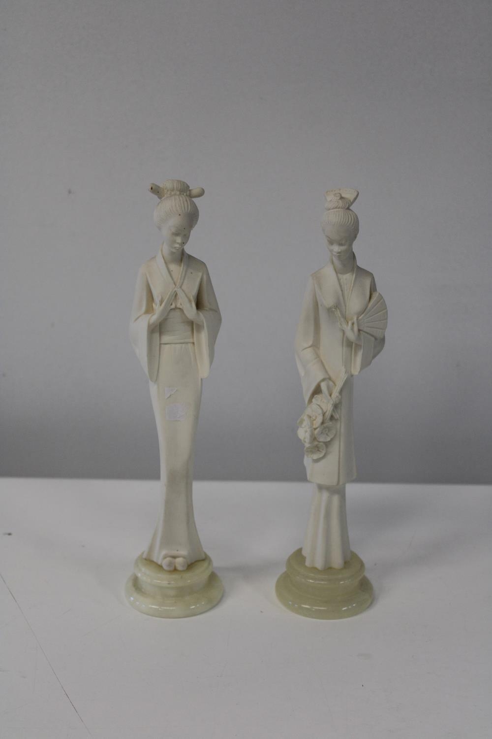 Two Oriental lady figures. 26cm tall