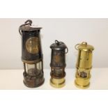 Three Miners lamps including Eccles. Largest lamp 26cm tall