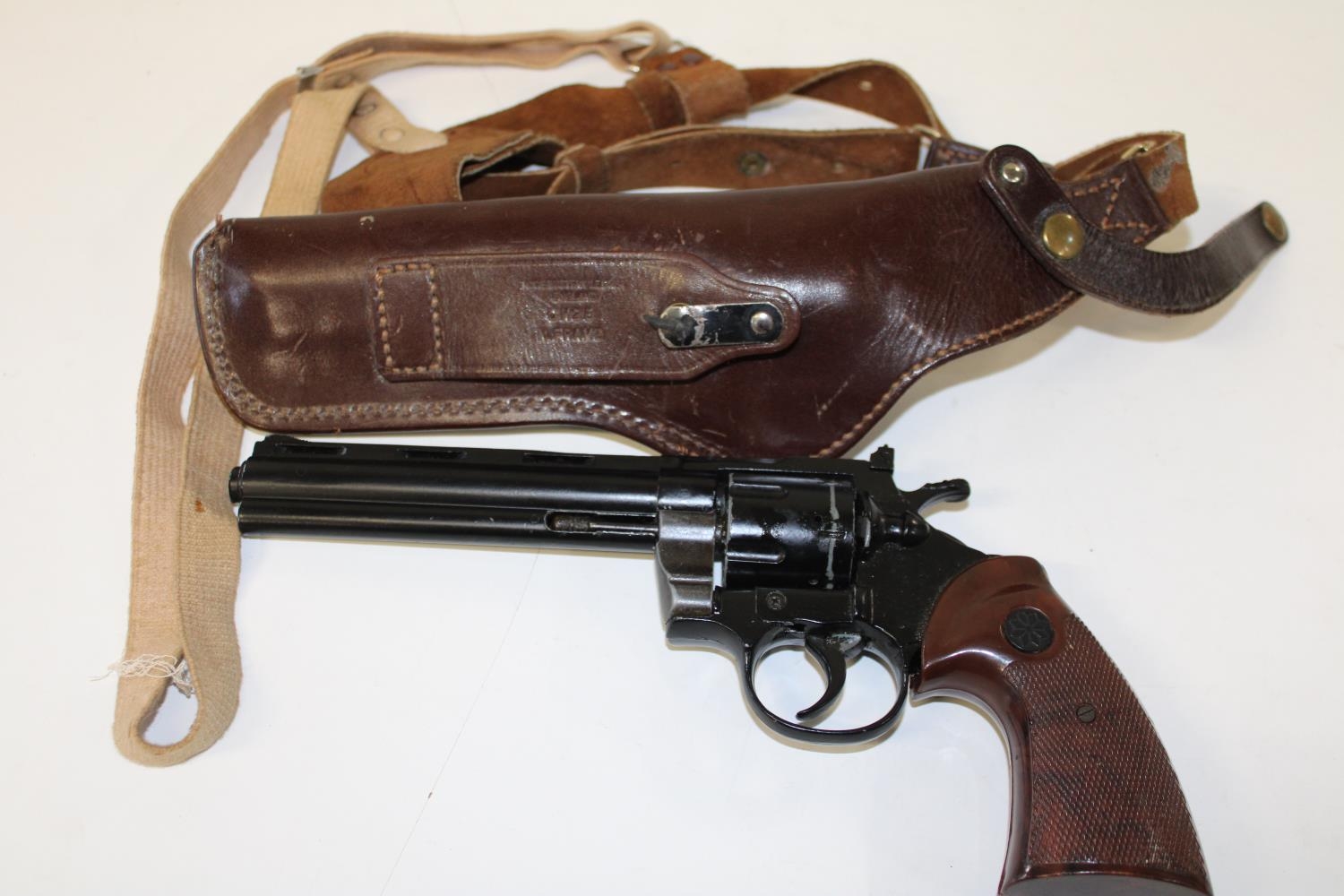 A replica gun & leather shoulder holster